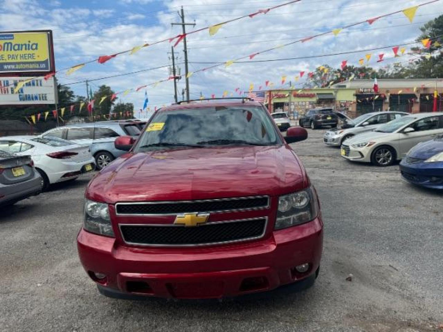 2014 Red Chevrolet Tahoe LT 2WD (1GNSCBE03ER) with an 5.3L V8 OHV 16V FFV engine, 6-Speed Automatic transmission, located at 1806 Veterans Memorial Hwy SW, Austell, GA, 30168, (770) 944-9558, 33.817959, -84.606987 - Photo#2