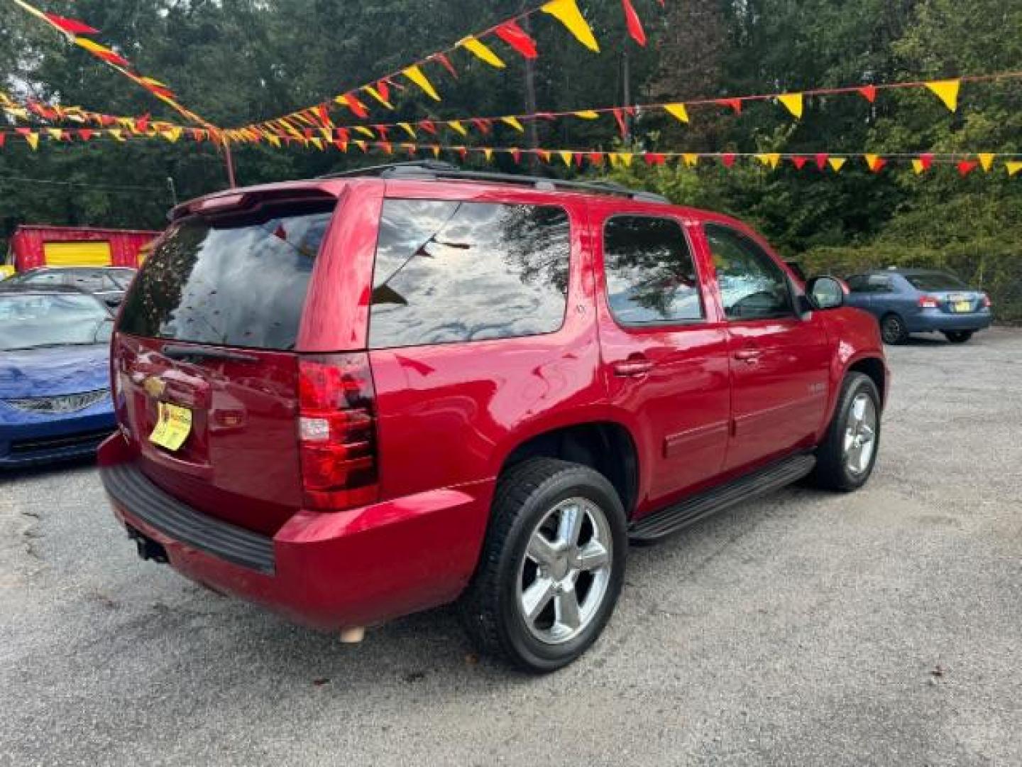 2014 Red Chevrolet Tahoe LT 2WD (1GNSCBE03ER) with an 5.3L V8 OHV 16V FFV engine, 6-Speed Automatic transmission, located at 1806 Veterans Memorial Hwy SW, Austell, GA, 30168, (770) 944-9558, 33.817959, -84.606987 - Photo#3