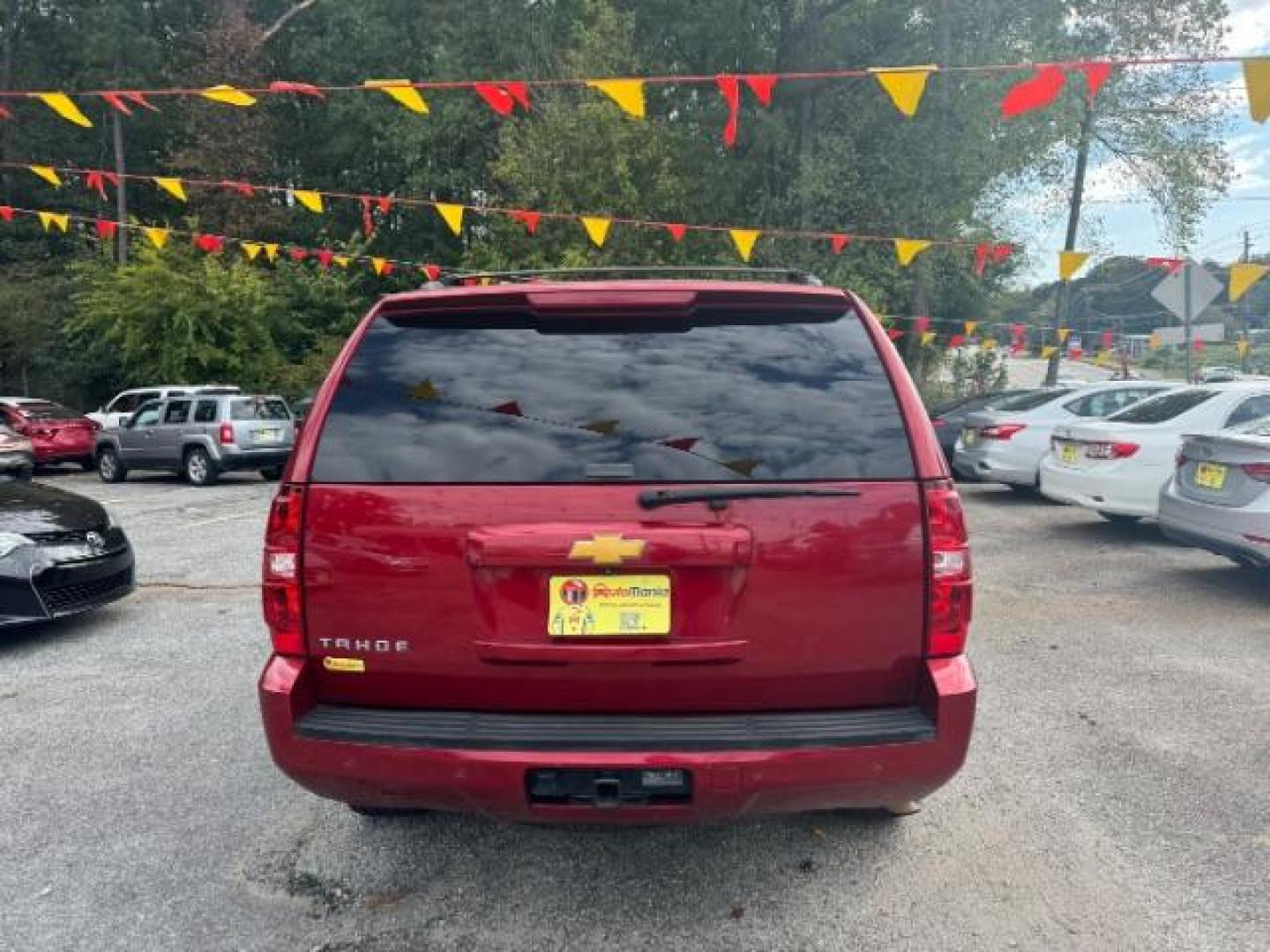 2014 Red Chevrolet Tahoe LT 2WD (1GNSCBE03ER) with an 5.3L V8 OHV 16V FFV engine, 6-Speed Automatic transmission, located at 1806 Veterans Memorial Hwy SW, Austell, GA, 30168, (770) 944-9558, 33.817959, -84.606987 - Photo#4