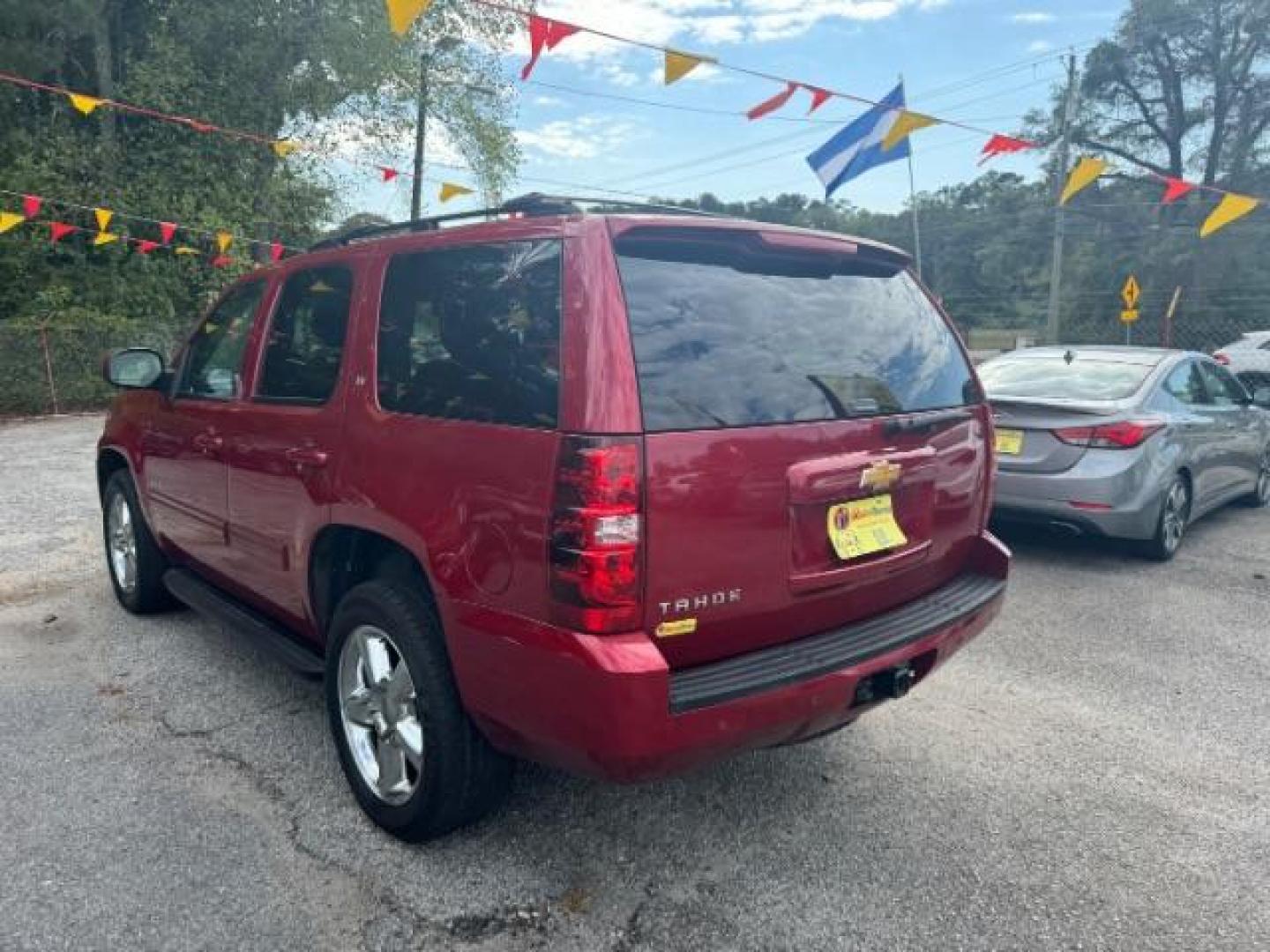 2014 Red Chevrolet Tahoe LT 2WD (1GNSCBE03ER) with an 5.3L V8 OHV 16V FFV engine, 6-Speed Automatic transmission, located at 1806 Veterans Memorial Hwy SW, Austell, GA, 30168, (770) 944-9558, 33.817959, -84.606987 - Photo#5