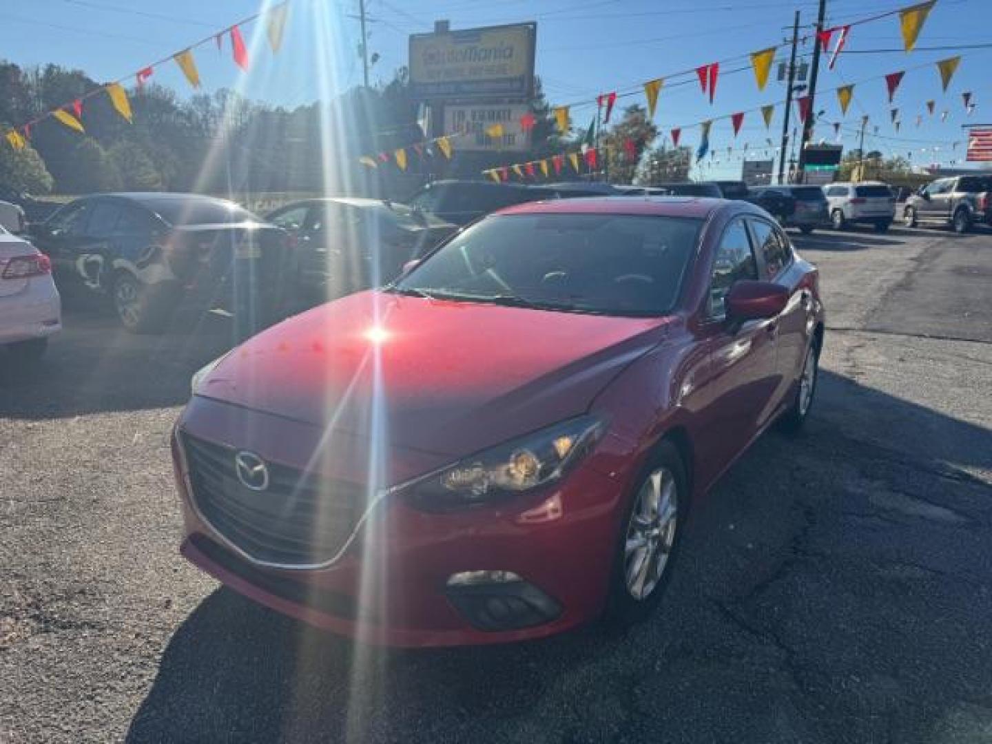 2015 Red Mazda MAZDA3 i Grand Touring AT 4-Door (3MZBM1W76FM) with an 2.0L L4 DOHC 16V engine, 6-Speed Automatic transmission, located at 1806 Veterans Memorial Hwy SW, Austell, GA, 30168, (770) 944-9558, 33.817959, -84.606987 - Photo#0