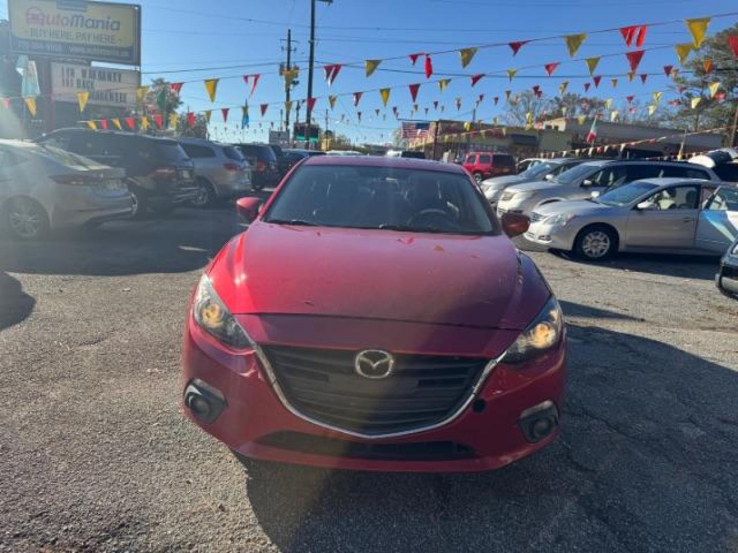 2015 Red Mazda MAZDA3 i Grand Touring AT 4-Door (3MZBM1W76FM) with an 2.0L L4 DOHC 16V engine, 6-Speed Automatic transmission, located at 1806 Veterans Memorial Hwy SW, Austell, GA, 30168, (770) 944-9558, 33.817959, -84.606987 - Photo#1