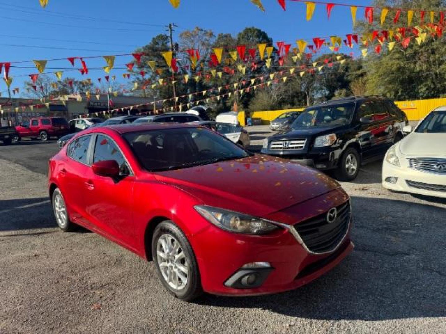 2015 Red Mazda MAZDA3 i Grand Touring AT 4-Door (3MZBM1W76FM) with an 2.0L L4 DOHC 16V engine, 6-Speed Automatic transmission, located at 1806 Veterans Memorial Hwy SW, Austell, GA, 30168, (770) 944-9558, 33.817959, -84.606987 - Photo#2