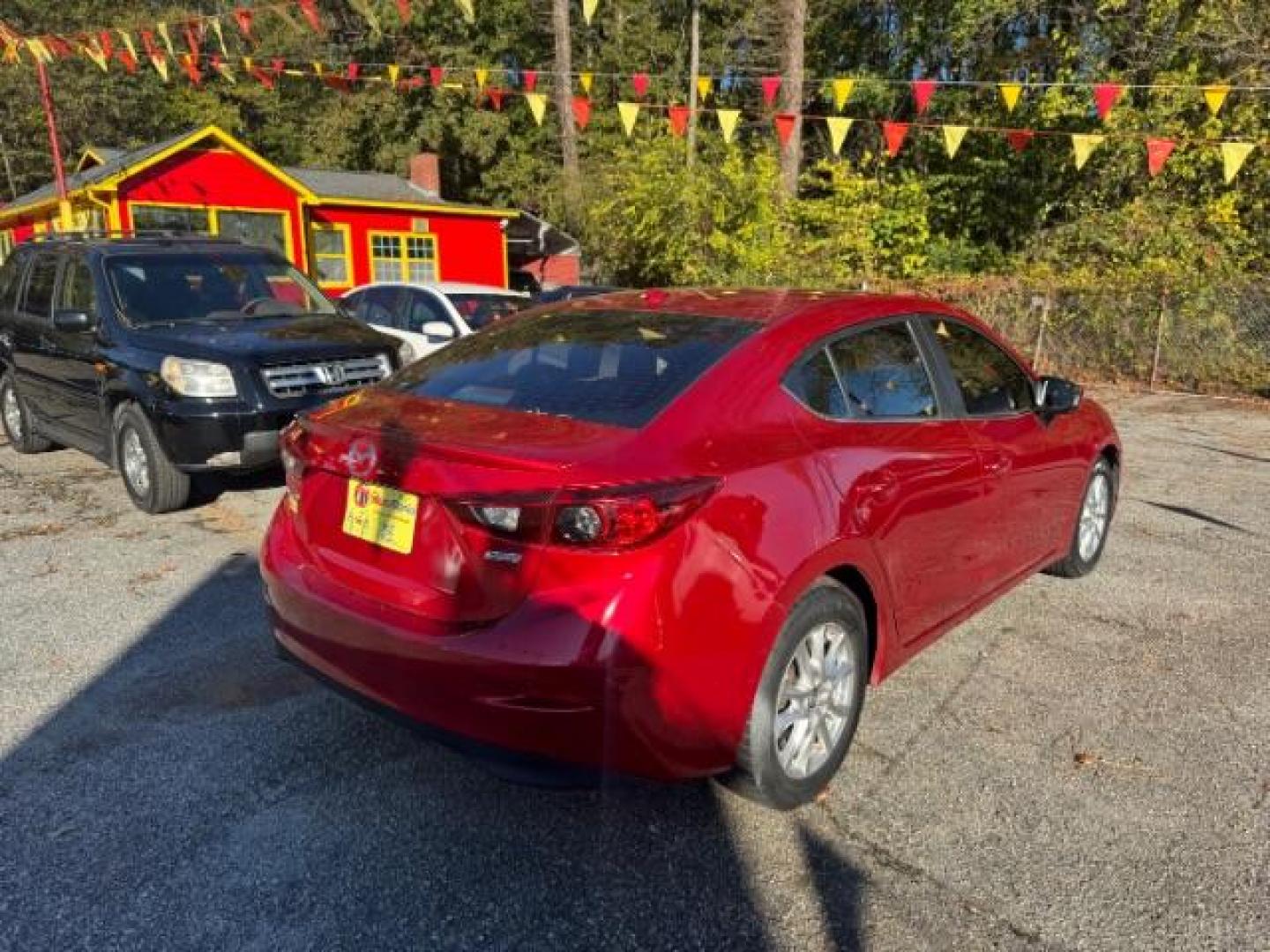 2015 Red Mazda MAZDA3 i Grand Touring AT 4-Door (3MZBM1W76FM) with an 2.0L L4 DOHC 16V engine, 6-Speed Automatic transmission, located at 1806 Veterans Memorial Hwy SW, Austell, GA, 30168, (770) 944-9558, 33.817959, -84.606987 - Photo#3