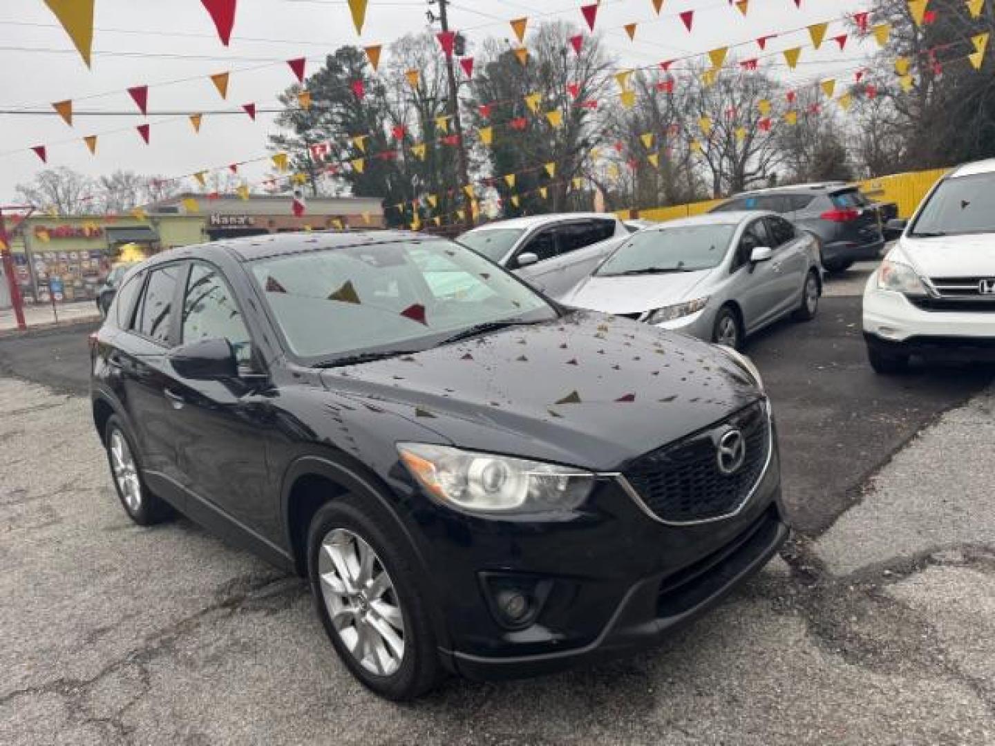 2015 Black Mazda CX-5 Grand Touring AWD (JM3KE4DY3F0) with an 2.5L L4 DOHC 16V engine, 6-Speed Automatic transmission, located at 1806 Veterans Memorial Hwy SW, Austell, GA, 30168, (770) 944-9558, 33.817959, -84.606987 - Photo#2