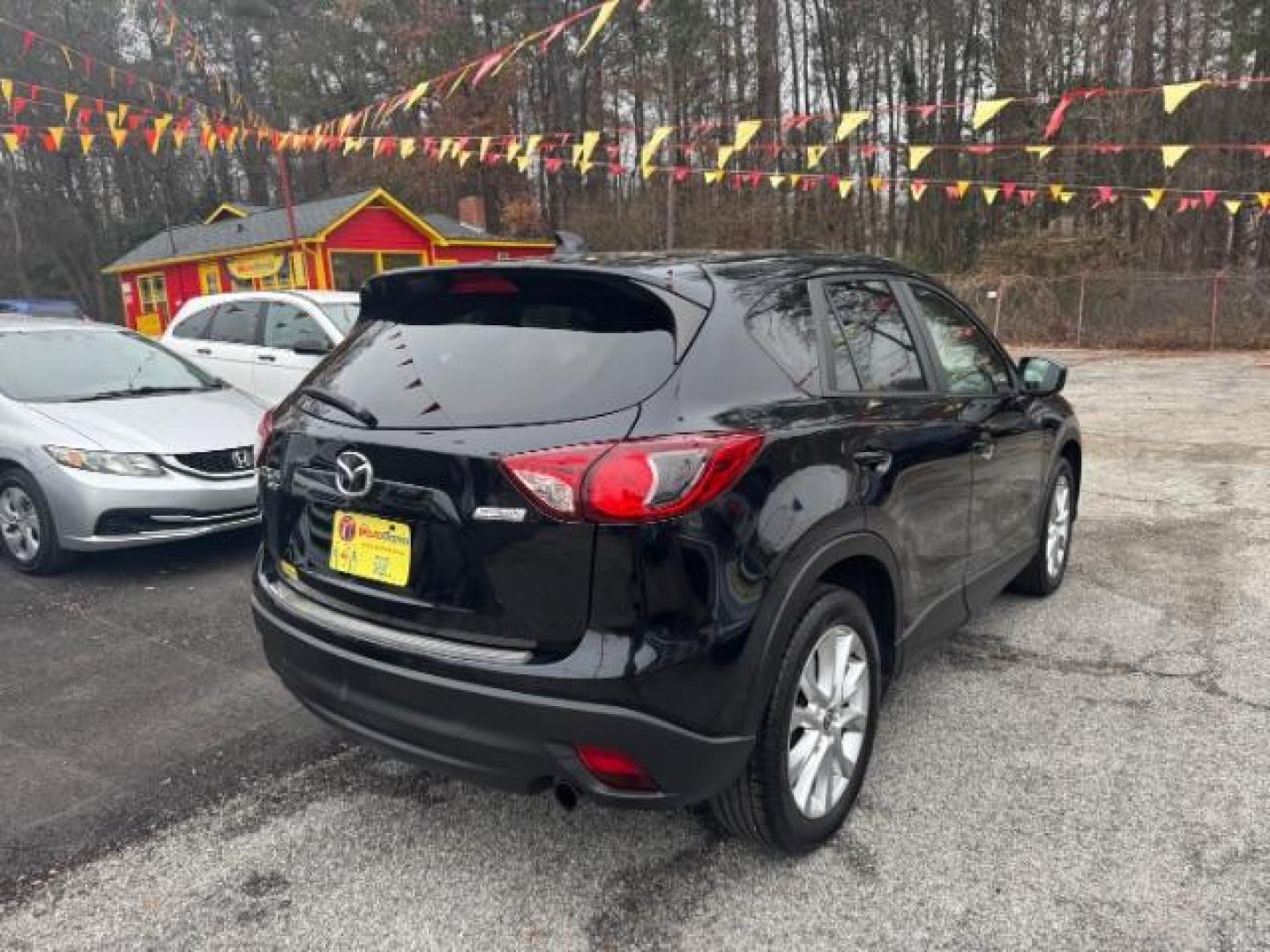 2015 Black Mazda CX-5 Grand Touring AWD (JM3KE4DY3F0) with an 2.5L L4 DOHC 16V engine, 6-Speed Automatic transmission, located at 1806 Veterans Memorial Hwy SW, Austell, GA, 30168, (770) 944-9558, 33.817959, -84.606987 - Photo#3