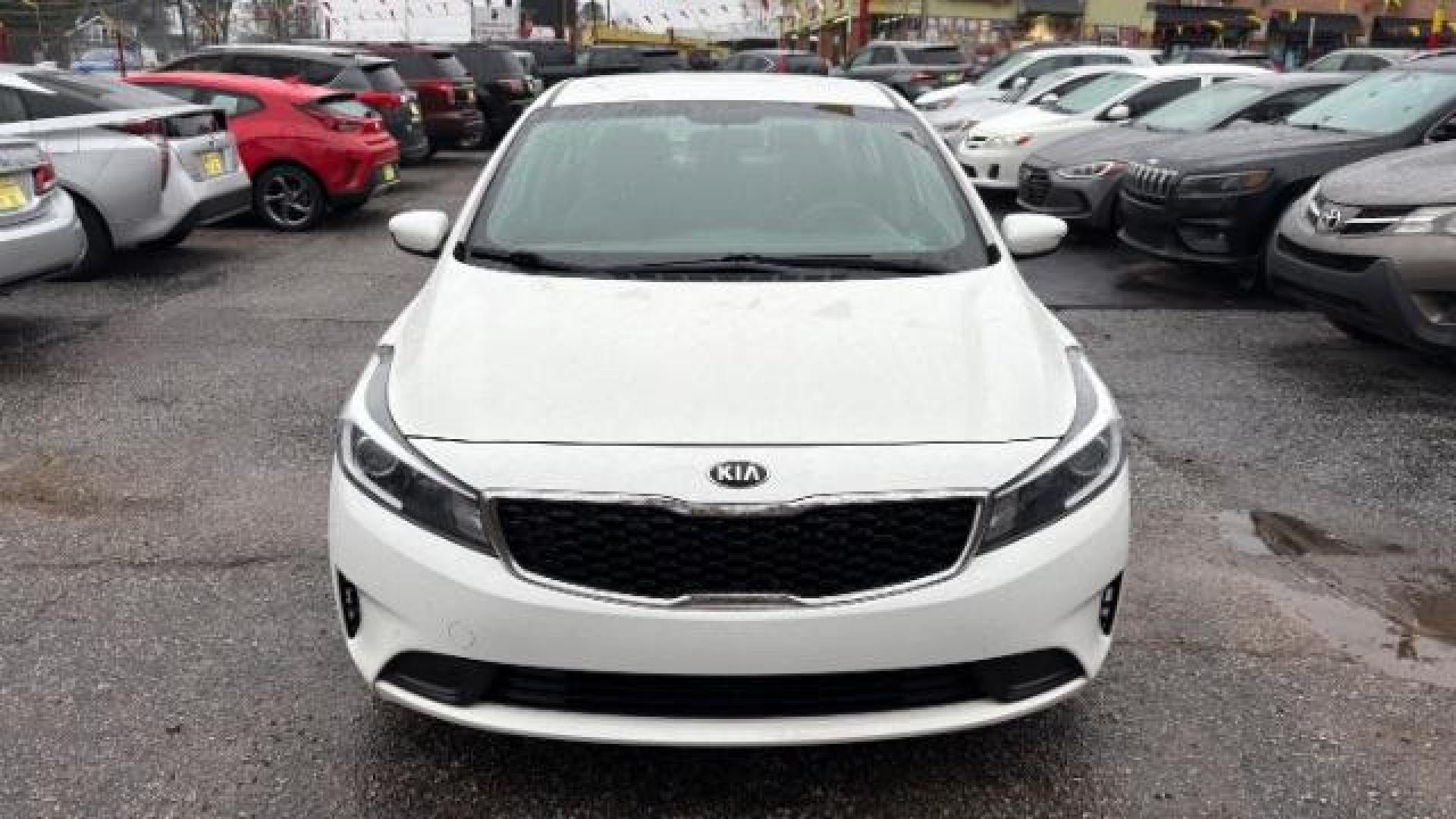 2017 White Kia Forte LX 6A (3KPFK4A78HE) with an 2.0L L4 DOHC 16V engine, 6-Speed Automatic transmission, located at 1806 Veterans Memorial Hwy SW, Austell, GA, 30168, (770) 944-9558, 33.817959, -84.606987 - Photo#1