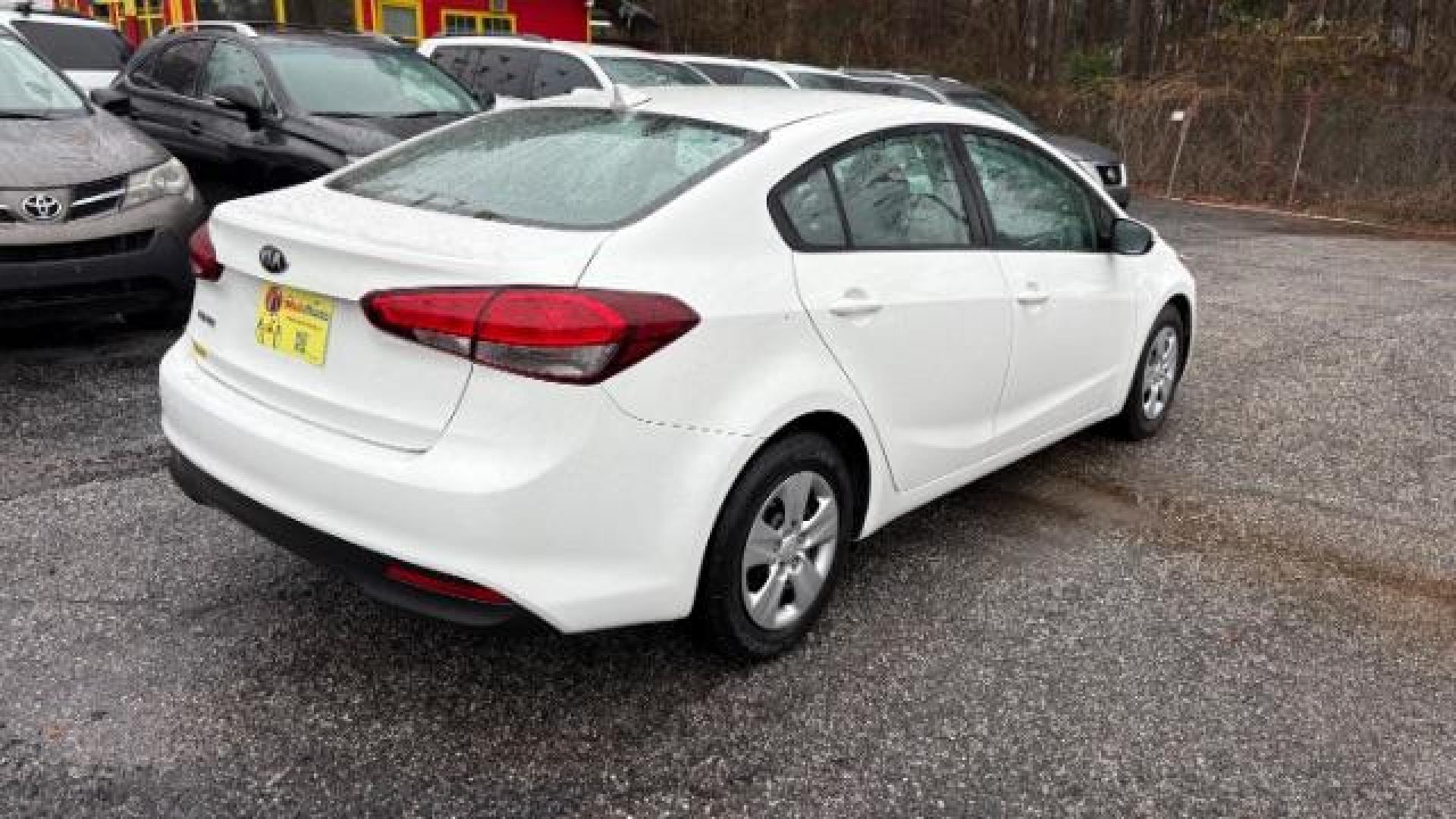 2017 White Kia Forte LX 6A (3KPFK4A78HE) with an 2.0L L4 DOHC 16V engine, 6-Speed Automatic transmission, located at 1806 Veterans Memorial Hwy SW, Austell, GA, 30168, (770) 944-9558, 33.817959, -84.606987 - Photo#3