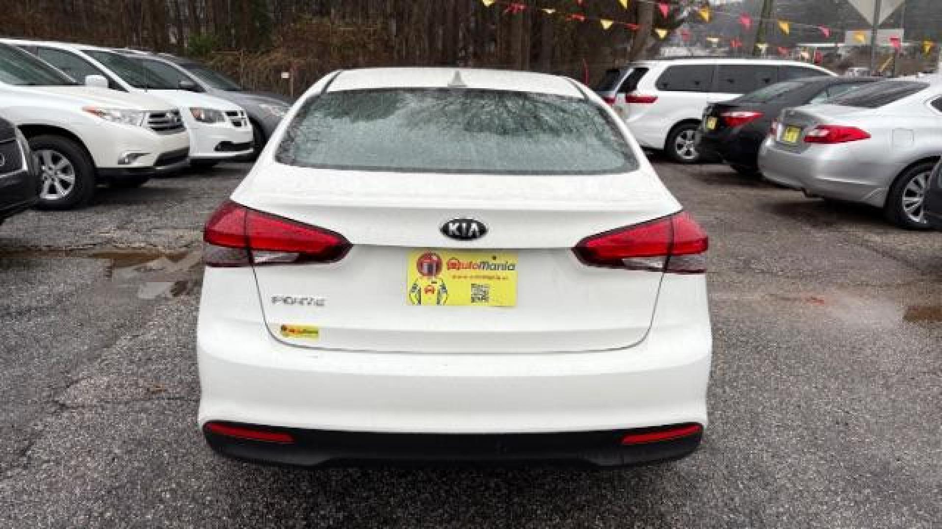 2017 White Kia Forte LX 6A (3KPFK4A78HE) with an 2.0L L4 DOHC 16V engine, 6-Speed Automatic transmission, located at 1806 Veterans Memorial Hwy SW, Austell, GA, 30168, (770) 944-9558, 33.817959, -84.606987 - Photo#4