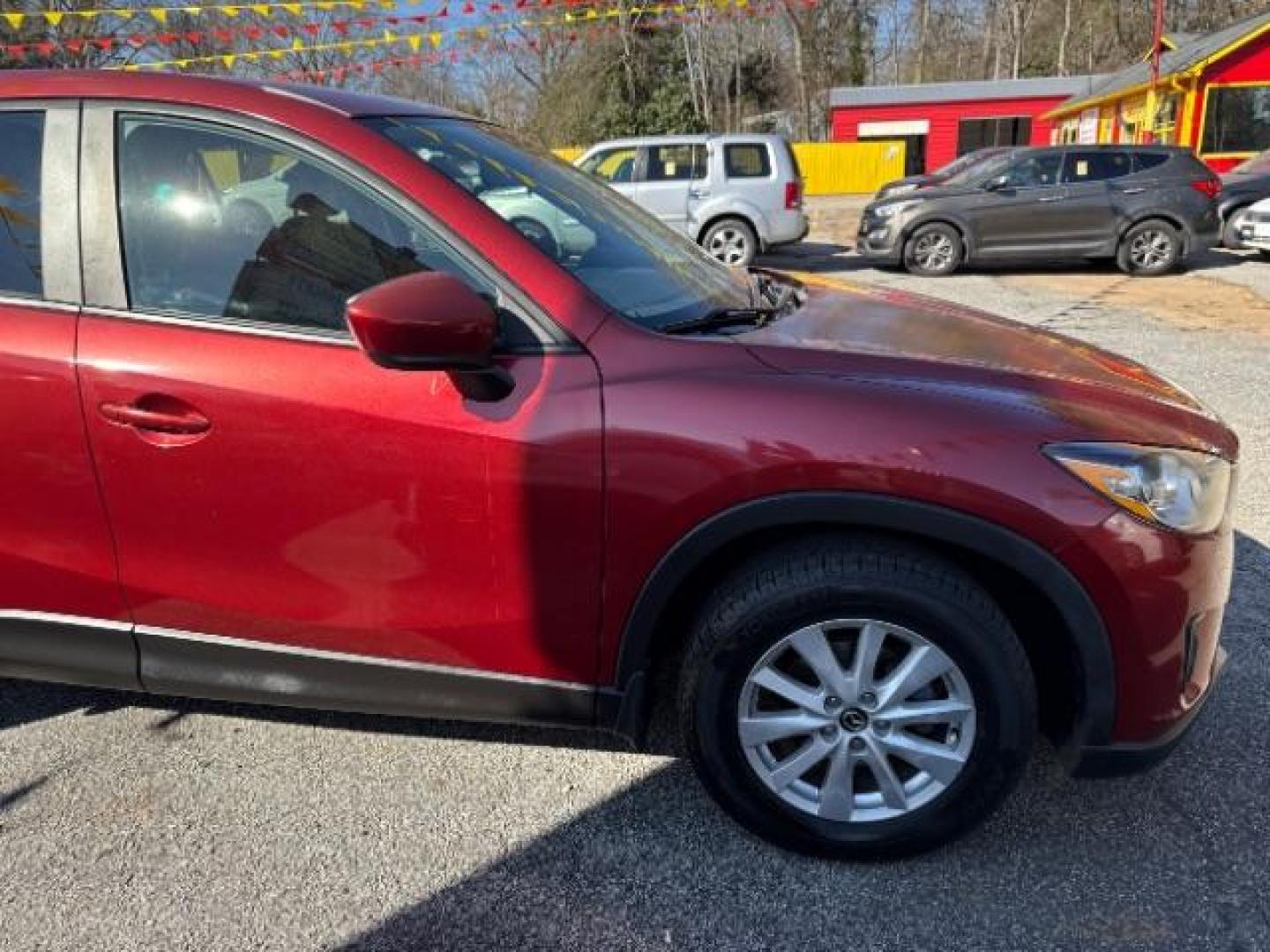 2013 Red Mazda CX-5 Touring (JM3KE2CE5D0) with an SKYACTIV-G 2L I-4 gasoline direct injection engine, located at 1806 Veterans Memorial Hwy SW, Austell, GA, 30168, (770) 944-9558, 33.817959, -84.606987 - Photo#9