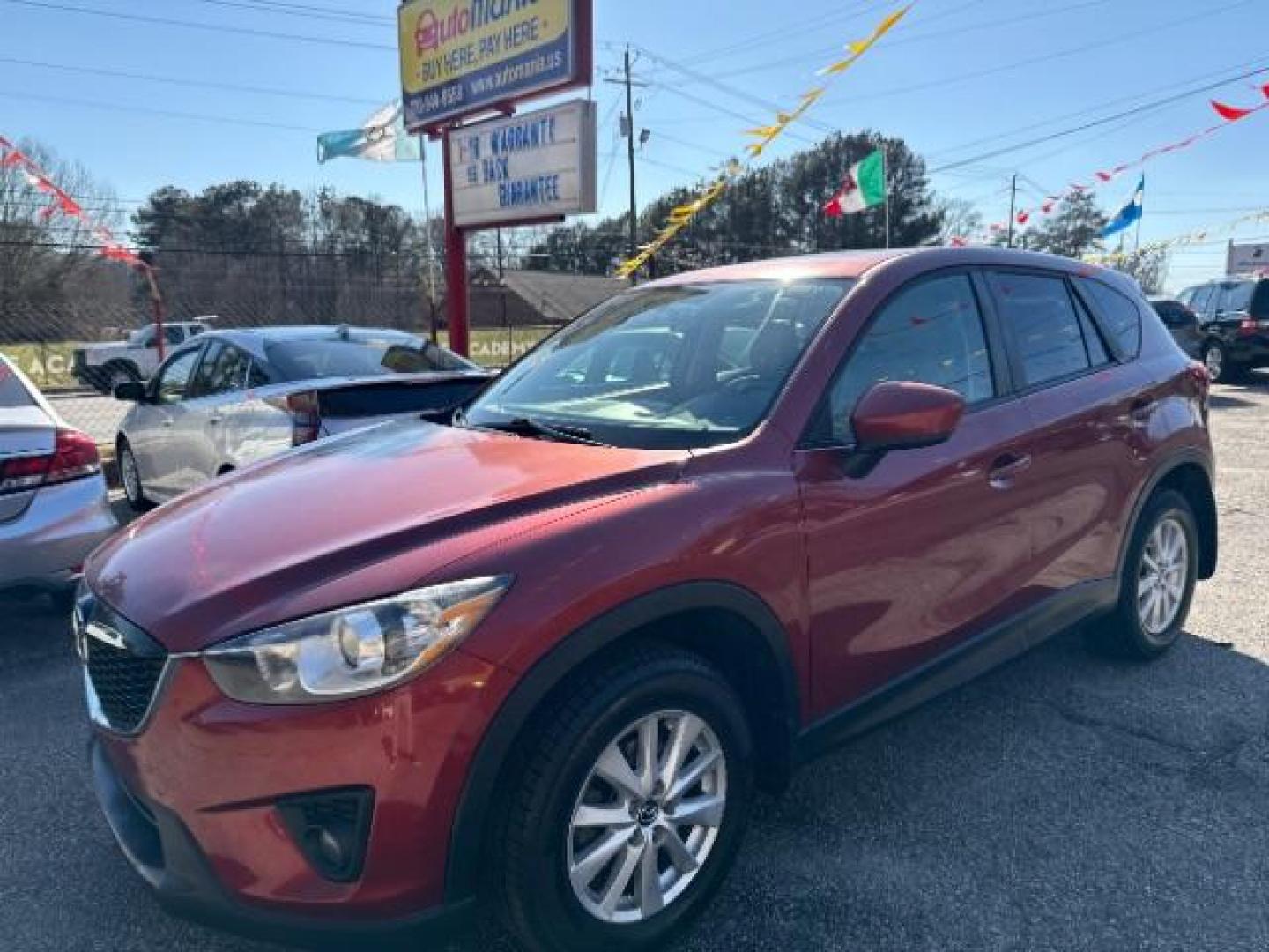 2013 Red Mazda CX-5 Touring (JM3KE2CE5D0) with an SKYACTIV-G 2L I-4 gasoline direct injection engine, located at 1806 Veterans Memorial Hwy SW, Austell, GA, 30168, (770) 944-9558, 33.817959, -84.606987 - Photo#0