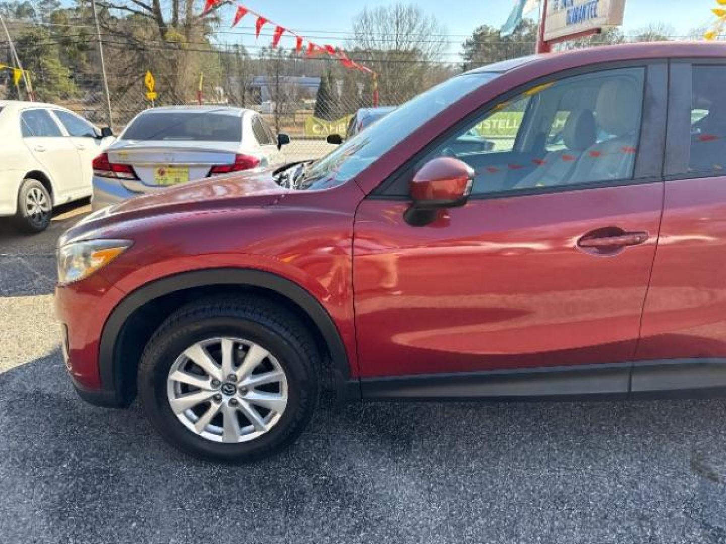 2013 Red Mazda CX-5 Touring (JM3KE2CE5D0) with an SKYACTIV-G 2L I-4 gasoline direct injection engine, located at 1806 Veterans Memorial Hwy SW, Austell, GA, 30168, (770) 944-9558, 33.817959, -84.606987 - Photo#1