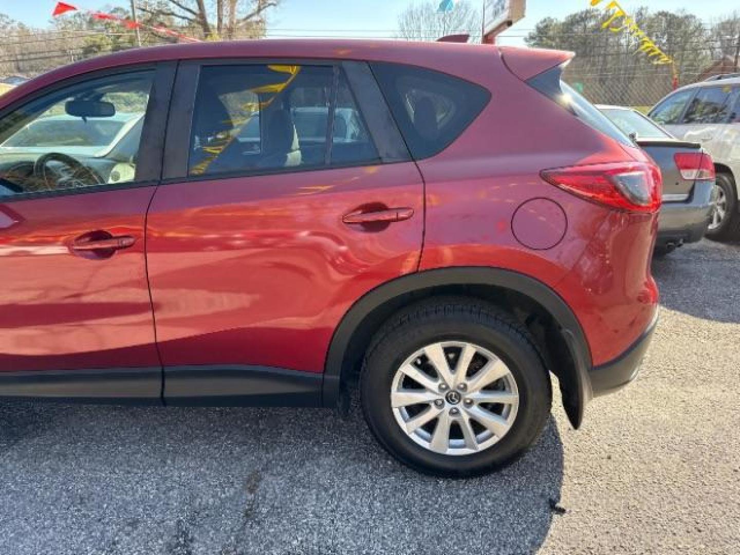 2013 Red Mazda CX-5 Touring (JM3KE2CE5D0) with an SKYACTIV-G 2L I-4 gasoline direct injection engine, located at 1806 Veterans Memorial Hwy SW, Austell, GA, 30168, (770) 944-9558, 33.817959, -84.606987 - Photo#2